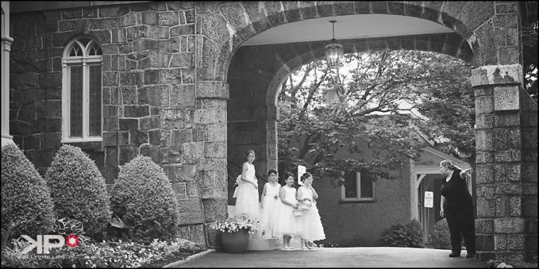 Kelly Phillips Whist flower girls waiting in the stone arch